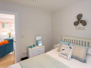 a bedroom with a bed with a fan on the wall at Egret in Brixham