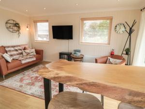 a living room with a couch and a table at 3 Valley View Lodges in York