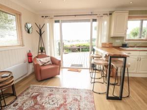 a kitchen with a counter and a table and chairs at 3 Valley View Lodges in York