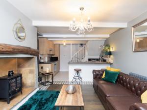 a living room with a couch and a table at Mischa Cottage in Bradford