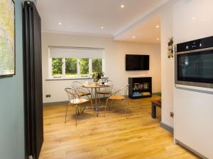 a kitchen and dining room with a table and chairs at Bellman Cottage in Windermere