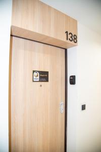 a large wooden door with a sign on it at Maya's Flats & Resorts 52 - Aura 40 in Gdańsk
