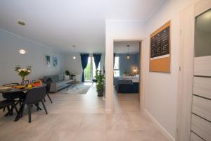 a living room and dining room with a dining table at Maya's Flats & Resorts 52 - Aura 40 in Gdańsk