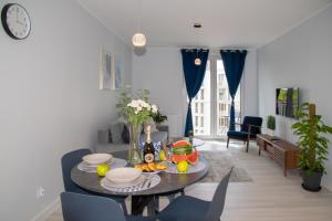 a living room with a table with food on it at Maya's Flats & Resorts 52 - Aura 40 in Gdańsk