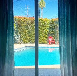 a view of a swimming pool from a window at Endless summer in LA *HEATED POOL/HOT TUB/CABANA* in Los Angeles