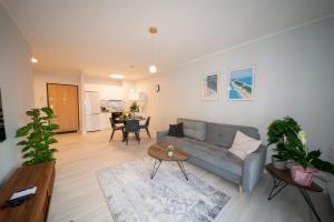 a living room with a couch and a table at Maya's Flats & Resorts 52 - Aura 40 in Gdańsk