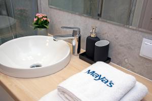 a bathroom sink with a towel on a counter at Maya's Flats & Resorts 52 - Aura 40 in Gdańsk