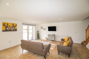 a living room with a couch and a tv at The Hideaway in Weymouth