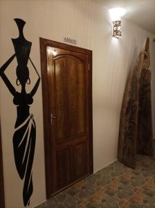 a door with a painting of a woman on a wall at Zanzicrown in Nungwi