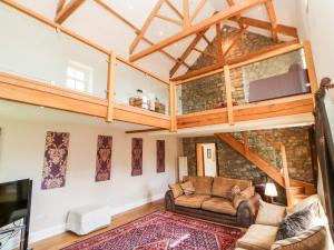 a living room with a loft bed and a couch at Crakesmire House in Darlington