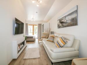 sala de estar con sofá blanco y TV en Westfields, en Launceston