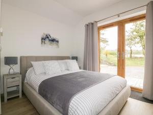 a bedroom with a bed and a sliding glass door at Westfields in Launceston
