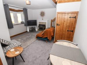 a living room with a bed and a fireplace at The Annexe in Keighley