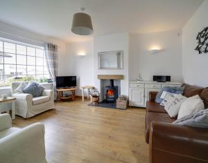 a living room with a couch and a fire place at Little Sark in Port Isaac