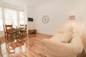 a living room with a couch and a table at Apartment 2 in Southsea