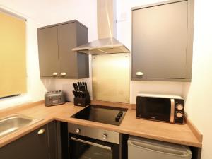 a kitchen with a sink and a microwave at Apartment 2 in Southsea