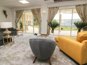 a living room with a couch and a chair at Myddelton Grange in Ilkley