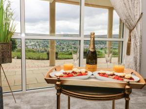 a table with a bottle of wine and plates of food at Myddelton Grange in Ilkley