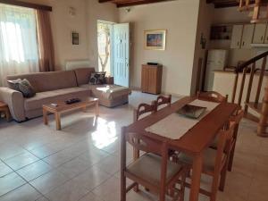 a living room with a couch and a table at Anna's House in Anavyssos