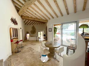 a large living room with a table and chairs at Villa IBIZA in Les Issambres
