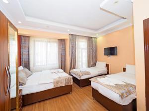 Postel nebo postele na pokoji v ubytování RENOVA hOTEL FATİH