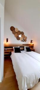 Postel nebo postele na pokoji v ubytování La Ferme du Soyeuru