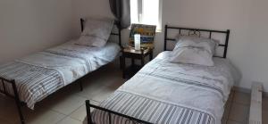 two beds sitting next to each other in a room at Le Casot in Torreilles