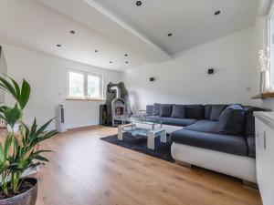 a living room with a couch and a table at Ferienwohnung Kurparkblick Sauerland in Lennestadt