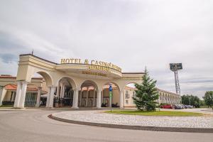 a hotel and casino building with a christmas tree in front at Casino & Hotel ADMIRAL Kozina in Kozina