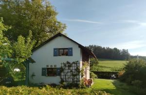 a small white house in a field with trees at Stodola in Cetenov