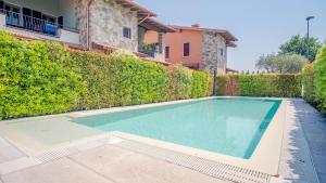 una piscina di fronte a una siepe di Endless Summer Sirmione - Italian Homing a Sirmione