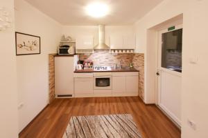 a kitchen with a sink and a stove top oven at Holiday house "Mimoza" 2 massage pools in Otočac