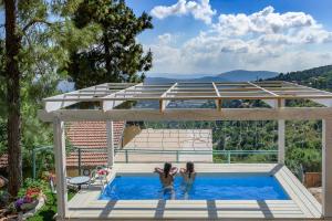 two women are standing in a swimming pool at Dream Time in Amirim