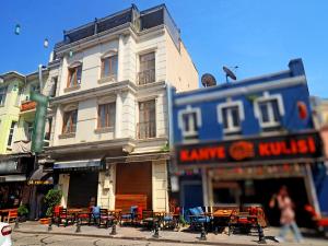 a building with tables and chairs on a city street at RENOVA hOTEL FATİH in Istanbul