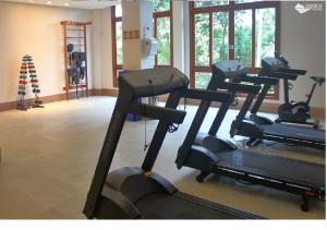 a gym with several tread machines in a room at VISTA AZUL FLAT RESIDENCIAL in Aracê