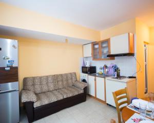 a living room with a couch and a kitchen at ALEKS Top Center in Burgas