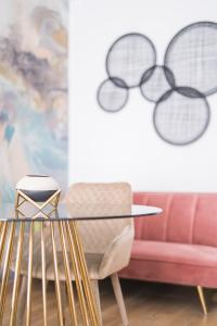 a living room with a glass table and a couch at Boutique La Gloria 1908 by Expoholidays in Almería +128 photos