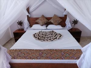 A bed or beds in a room at Zanzicrown