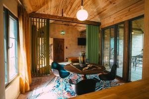 a living room with a table and chairs at Domaine Bohème I art de vivre in Guebwiller