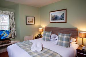 Ένα ή περισσότερα κρεβάτια σε δωμάτιο στο White Hart Inn