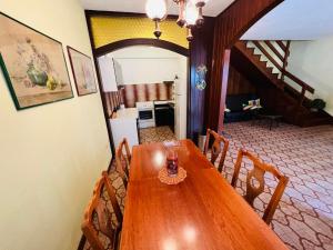 a dining room with a wooden table and chairs at Sea breeze Apartments with boat Anchorage in Stara Novalja