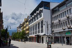 a city street with tall buildings on a street at Hotel Freya in Struga