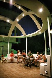 法里拉基的住宿－奧米洛斯酒店，一群人坐在一张沙发上的桌子旁