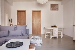 a living room with a couch and a table at Maison Central in Mikonos