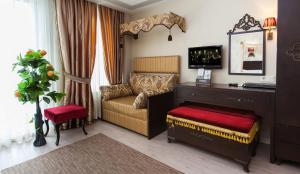 a bedroom with a couch and a desk in a room at Cosmos Hotel Istanbul in Istanbul