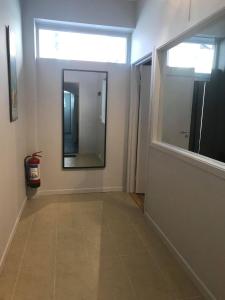 a hallway with a large mirror and a window at Notodden Sentrum Apartment NO 10 in Notodden