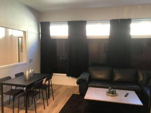 a living room with a couch and a table at Notodden Sentrum Apartment NO 10 in Notodden