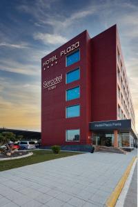 a large red building with a sign on it at Sercotel Plaza Feria in Zaragoza