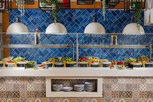 a buffet line with dishes and appetizers at AQI Hydros Club in Kemer