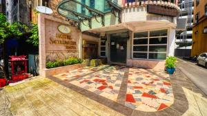 a building with a tiled sidewalk in front of a building at Hotel Seniman in Kuala Lumpur